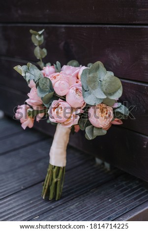 Closeup of beautiful pink rose bouquet held by a gracious bride