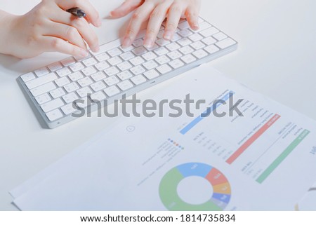 work and learn online in new normal concept from woman typing on wireless keyboard with business document and white isolated background
