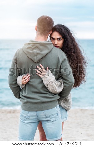 Young couple at the beach being sweet and in love. Boyfriend and girlfriend outdoors photoshoot