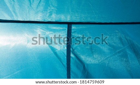 Sun through blue nylon tent