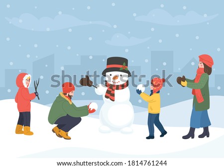 Family making snowman. Man, woman and children building snowman. Winter holidays with place for your text. Royalty-Free Stock Photo #1814761244