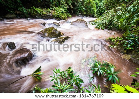 Waterfall in rainy season color water is brown at Thailand , slow shutter 