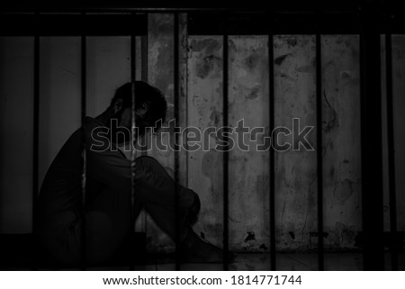 Asian man desperate at the iron prison,prisoner concept,thailand people,Hope to be free,Serious prisoners imprisoned in the prison Royalty-Free Stock Photo #1814771744