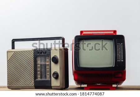 Retro media. Old portable tv, radio receiver on a white background