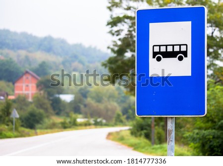 traffic signs, notice that there is a bus stop nearby
