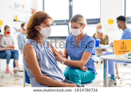 Woman with face mask getting vaccinated, coronavirus, covid-19 and vaccination concept. Royalty-Free Stock Photo #1814780726