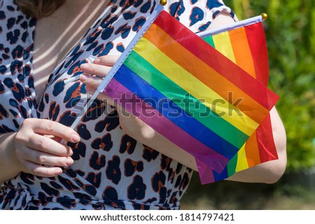 A woman with a rainbow flag supporting the LGBT movement
