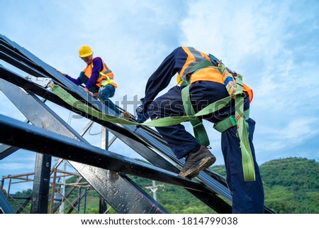 Roofer worker using drill install new roof on house build,Roofing tools.
