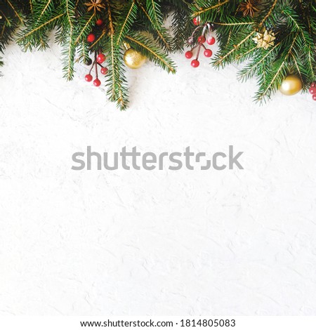 Twigs of Christmas tree and Christmas decoration on white stone background. Copy space. Christmas background.