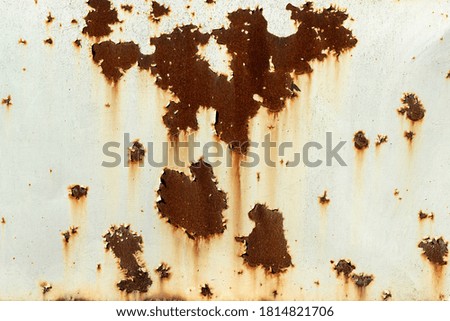 Rusty metal background under peeled paint