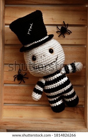 Halloween crochet with cute ghost, pumpkins, spiders, witch hat, knitting, handmade, kid, childhood, children, funny, toys in white and vintage wooden crate box background