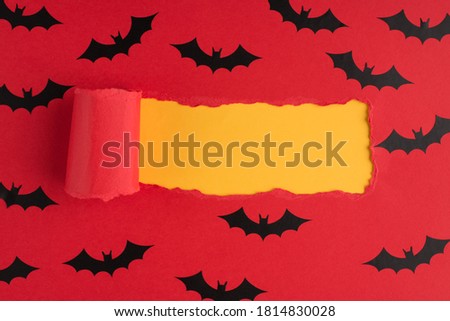 Top above overhead view photo of torn red paper and bats over yellow background with copyspace