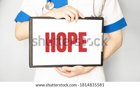 Doctor holding a paper plate with text HOPE, medical concept