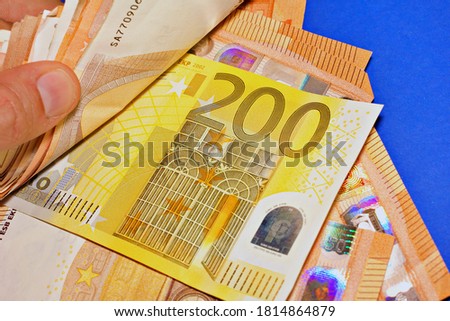 close up of a hand counting euro banknotes