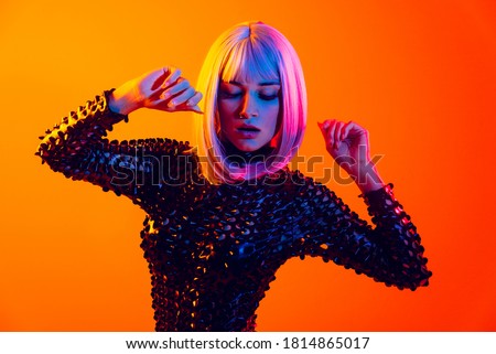 Fashion portrait of beautiful woman on colored background Royalty-Free Stock Photo #1814865017