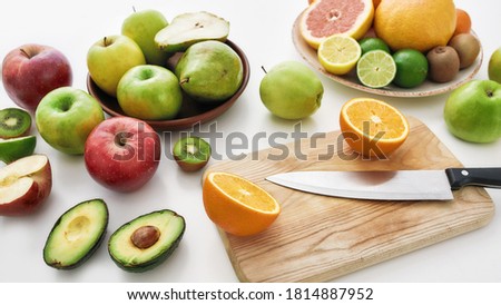 Close up of various colorful fresh summer fruits, Sliced fruits and a knife on cutting board isolated over white background, Web Banner