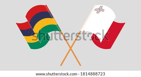 Crossed and waving flags of Mauritius and Malta