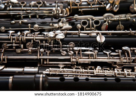 Many woodwind instruments lie on a wooden surface. View from above. Royalty-Free Stock Photo #1814900675