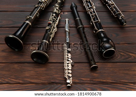 Woodwind instruments lie on a wooden surface. View from above Royalty-Free Stock Photo #1814900678