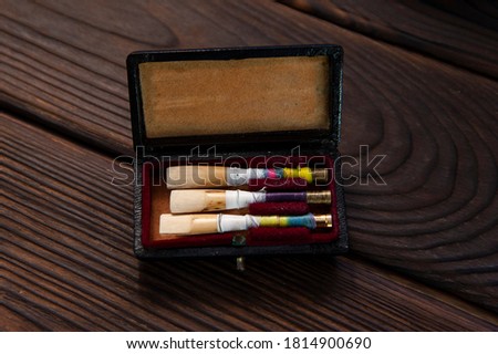 Set of oboe reeds on a wooden surface Royalty-Free Stock Photo #1814900690