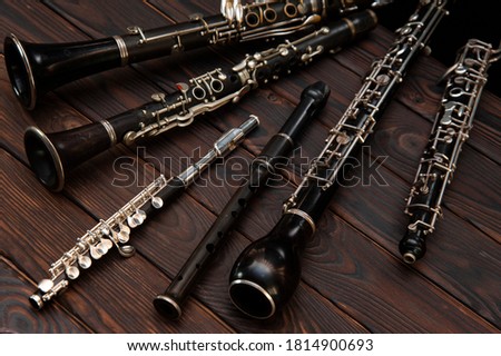 Woodwind instruments lie on a wooden surface. View from above Royalty-Free Stock Photo #1814900693