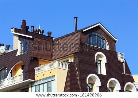 Mansard with a balcony, figured windows and brown roof