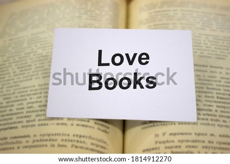 Love books written in white note on open books