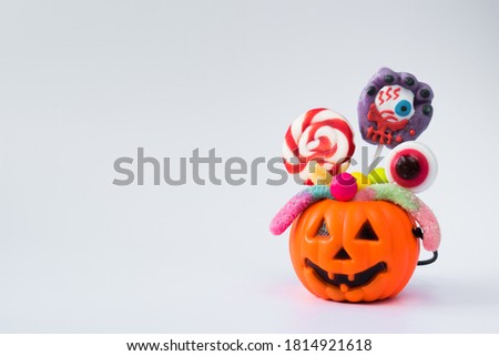 Pumpkin with various sweets on a white background with a copy of the space.