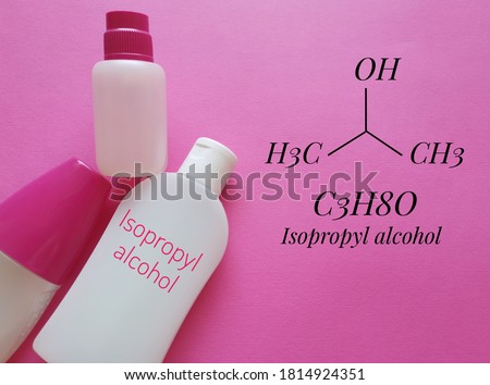 Structural chemical formula of isopropyl alcohol (2-propanol) with disinfectant or sanitizer in plastic packaging. Isopropanol is used as a rubbing-alcohol antiseptic, hand sanitizer, cleanser, etc. Royalty-Free Stock Photo #1814924351