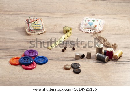 A closeup shot of sewing accessories on the wooden table