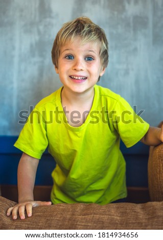 Portrait mischievous cute blond blue eyed boy making freckles face play laughing in happy mood. Funny photo, happiness lifestyle. Daycare, simple joys happy childhood, behaviour education psychology