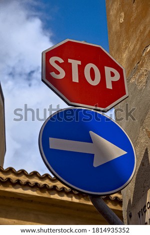 Stop sign and one way only sign with a clear sky as background