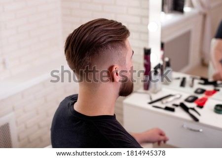 Male head with stylish haircut on barbershop background Royalty-Free Stock Photo #1814945378