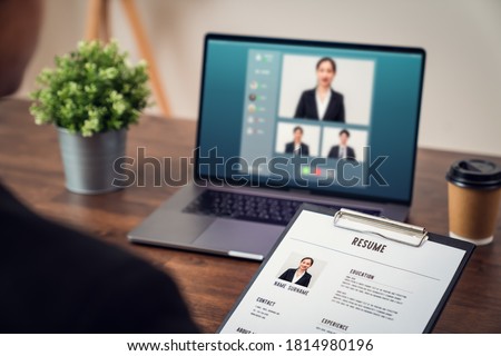 Company HR is holding a resume application in hand. Video calling, chatting and interviewing online jobs via digital laptop, Technology network saves time and is easy to coordinate.