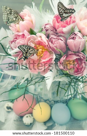 easter decoration with pink tulip flowers, butterflies and colored eggs. vintage style colored picture