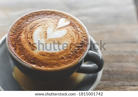 Cappuccino coffee close up in the making above wooden table Royalty-Free Stock Photo #1815001742