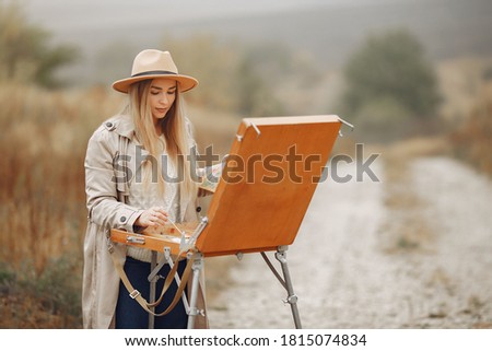 Woman in a autumn field painting.
