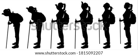 Tourist with a backpack on her back and a walking stick. Group of tourists follow each other. Hiking. Girl leans and looks away. Female silhouette is isolated on a white background.
