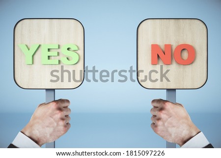 Businessman hands holding yes and no sign on blue background. Business and choice concept