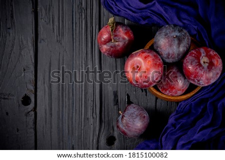 Purple plum on black background