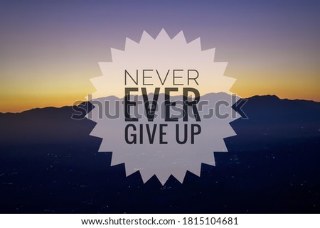 Never give up quote with sunset background.