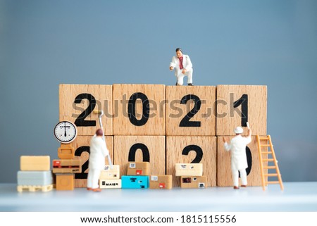 Miniature worker team painted number 2021 and remove number 2020 , Happy new year concept