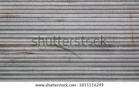 Background of galvanized corrugated tin iron with traces of rust and horizontal orientation