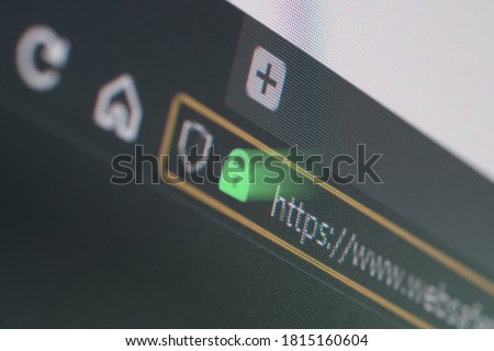 Dark web browser close-up on LCD screen with shallow focus, light shining through https padlock. Internet security, SSL certificate, cybersecurity, search engine and web browser concepts