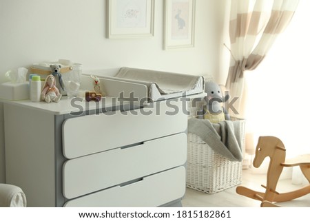 Modern changing table in baby room interior