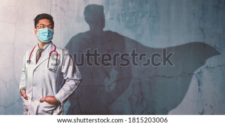 Brave Doctors with his shadow of superhero on the wall. Concept of powerful man Royalty-Free Stock Photo #1815203006