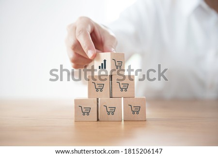 Sale volume increase make business grow, Flips cube with icon growth graph and shopping cart symbol. Royalty-Free Stock Photo #1815206147