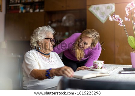 Young woman spending time with her elderly grandmother at home
 Royalty-Free Stock Photo #1815223298