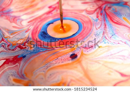 Beautiful ornament from the ink floated on water.A person draw it with wooden stroke. Royalty-Free Stock Photo #1815234524