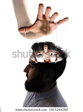 Marionette in human head. Concept of mind control. Image Royalty-Free Stock Photo #1815246380